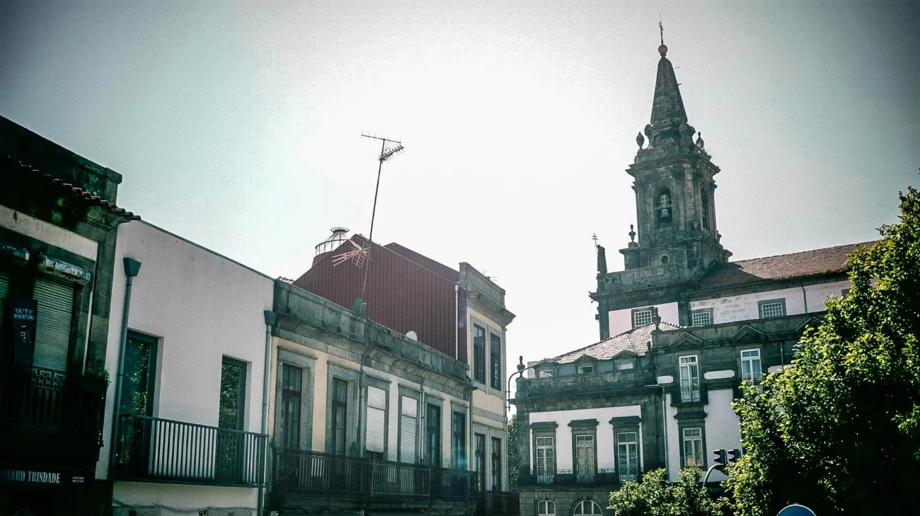 A church bell tower rising above Porto’s rooftops