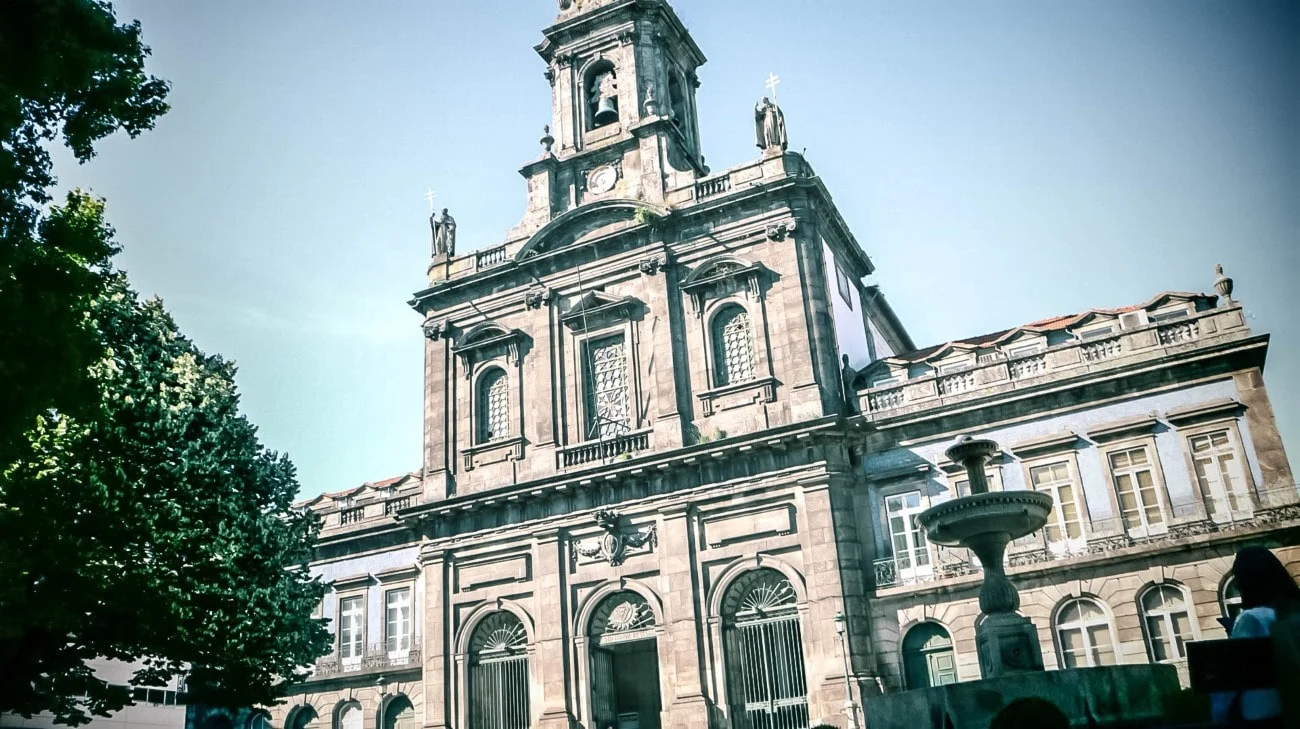 The baroque facade of Igreja da Trindade with its bell tower