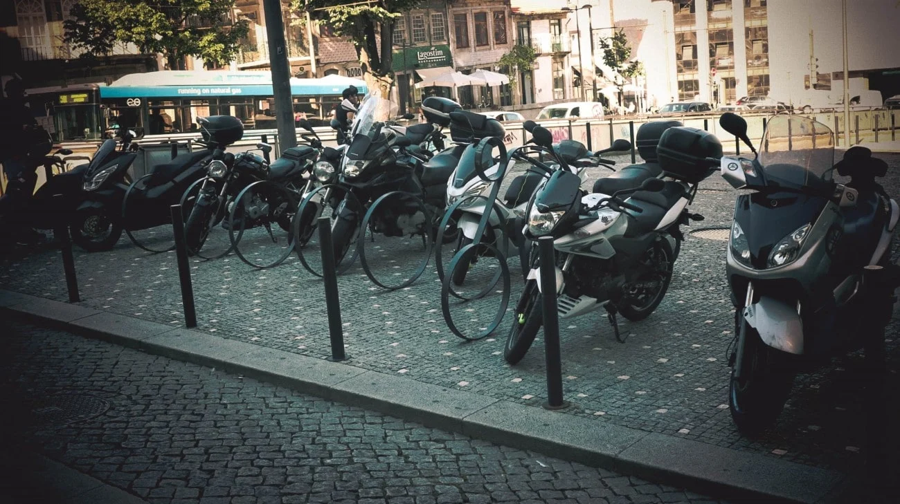 Motorcycles and scooters parked on cobblestone streets