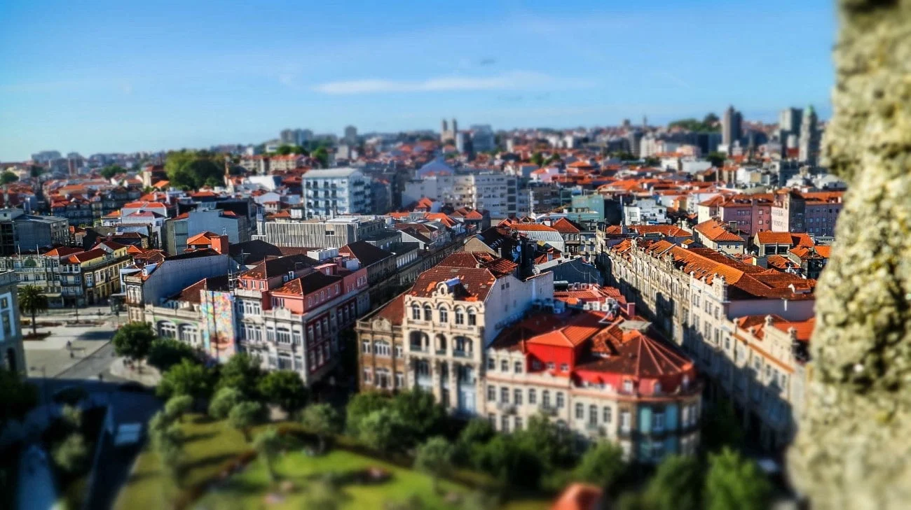 Tilt-shift view over colorful buildings and red rooftops from the tower