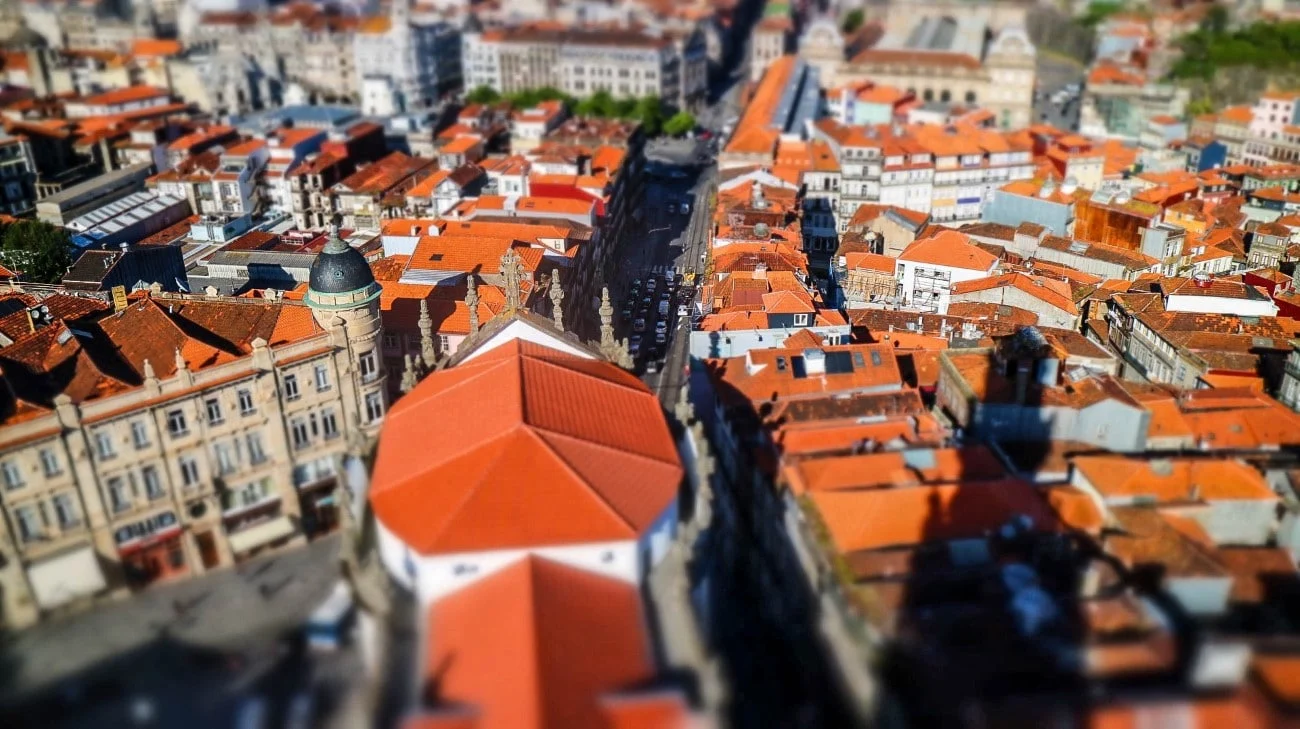 Tilt-shift aerial view looking down a main avenue through Porto’s old town