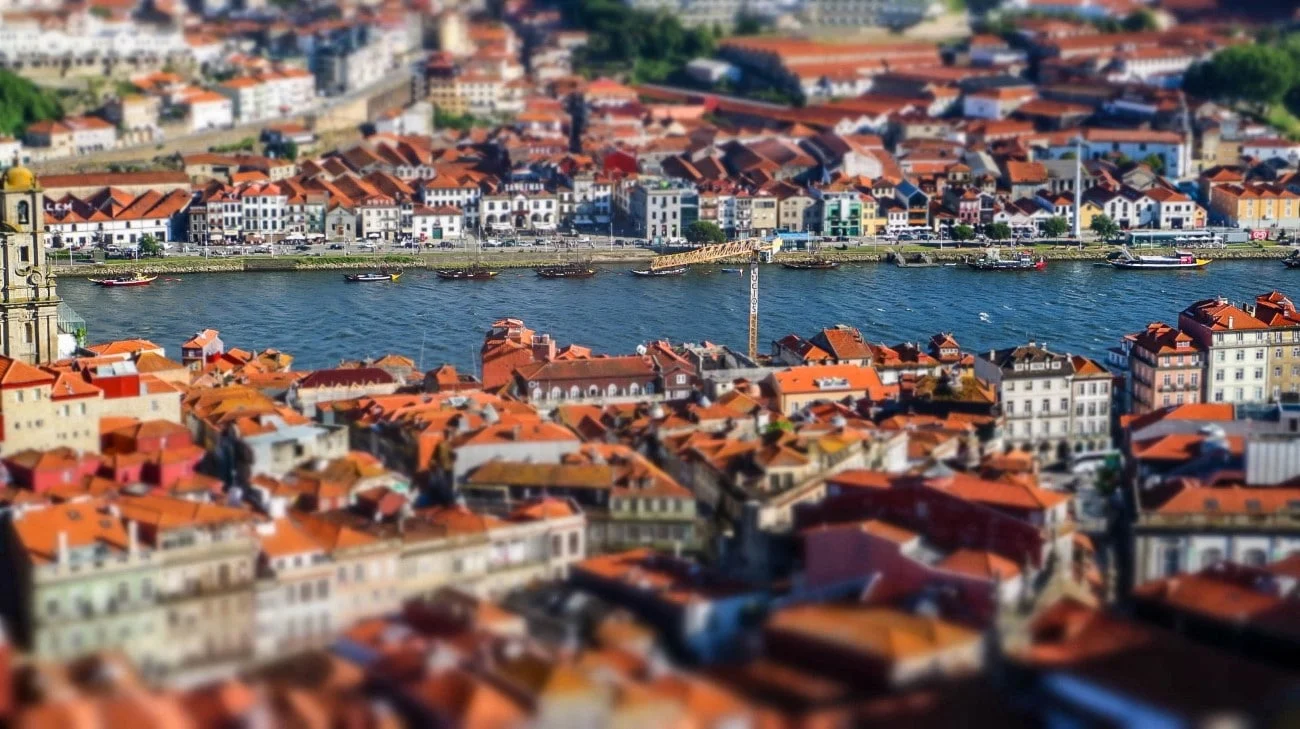 Tilt-shift view of the Douro River with boats and Vila Nova de Gaia across the water
