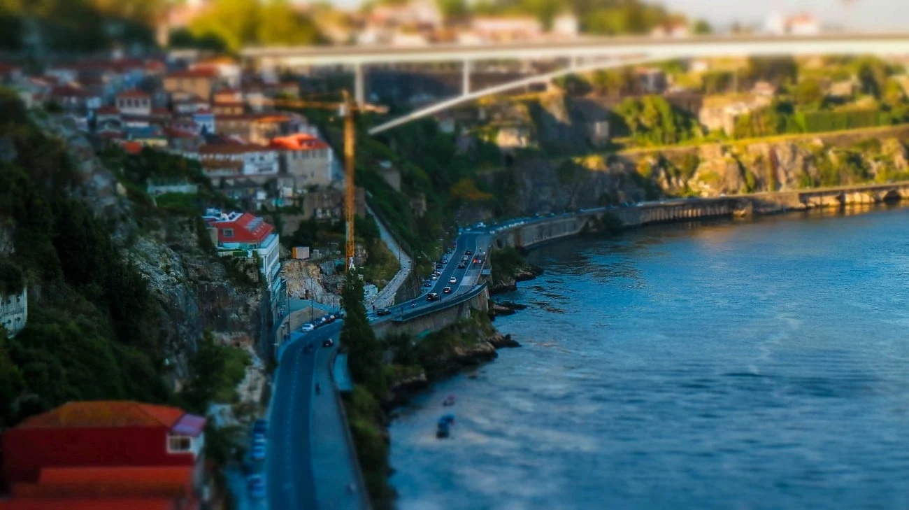 Tilt-shift view of a road winding along the Douro River cliffs