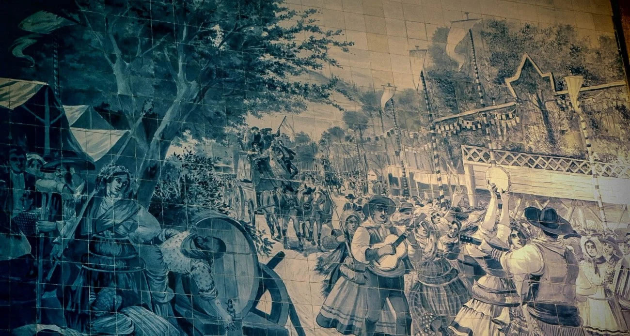 Azulejo tile mural depicting a traditional folk festival inside São Bento station