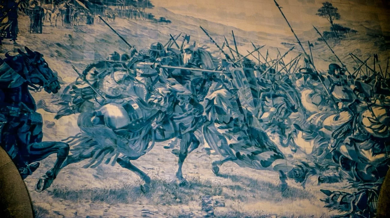 Azulejo tile mural of a cavalry charge inside São Bento station