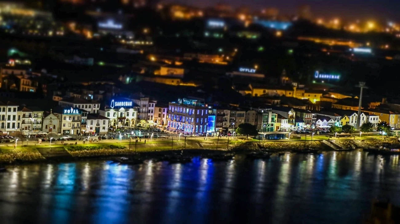 Vila Nova de Gaia’s Port wine cellars lit up at night across the Douro River