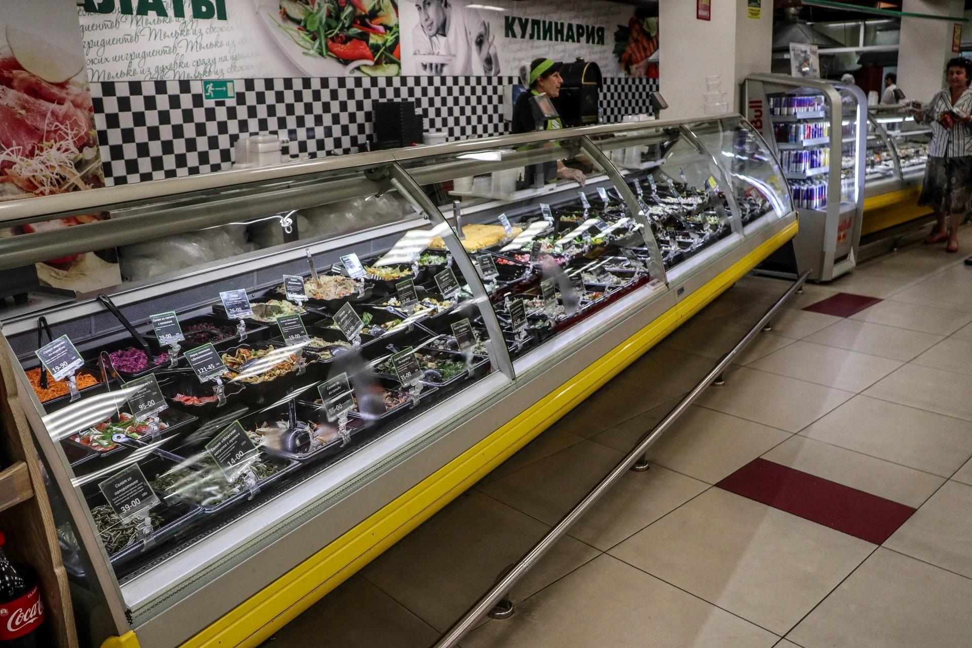 Supermarket deli counter packed with prepared salads, a Russian institution