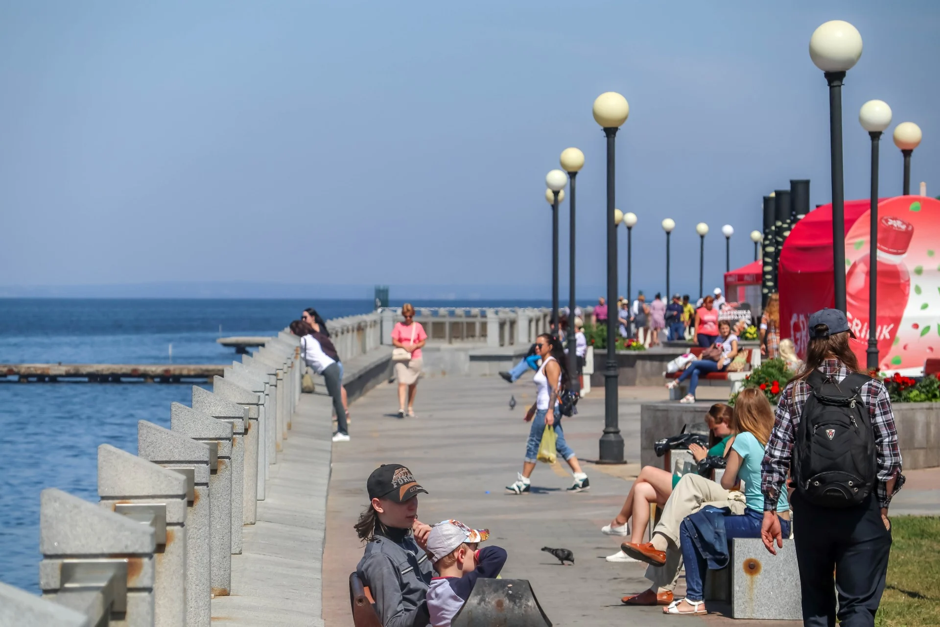 Sport Harbor promenade on a Sunday afternoon, locals out for the rare warm weather