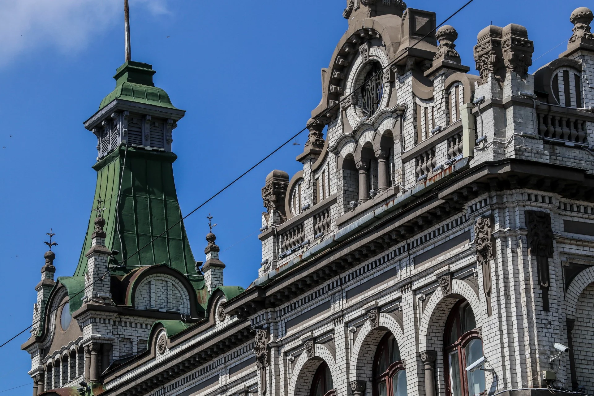 Green spire and corner turret of a pre-revolution merchant building