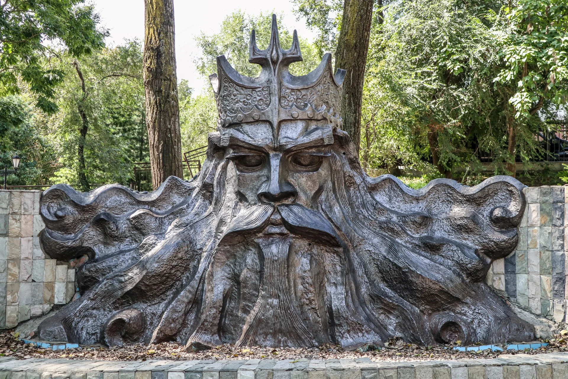 A bronze Neptune sculpture in the park, the city’s Greek-myth founding-myth