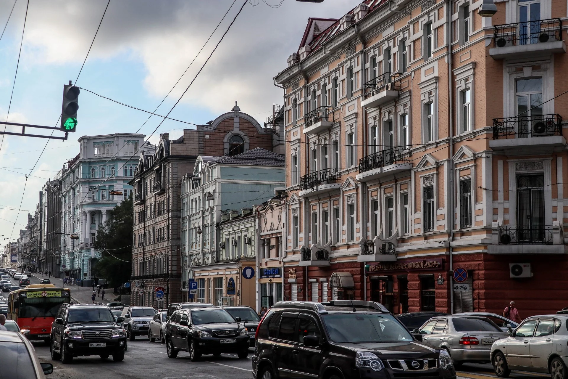 Downtown street with traffic threading past historic facades