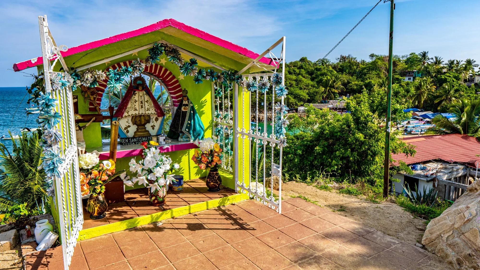 A small catholic shrine sits in front of the beach in Puerto Escondido, Mexico