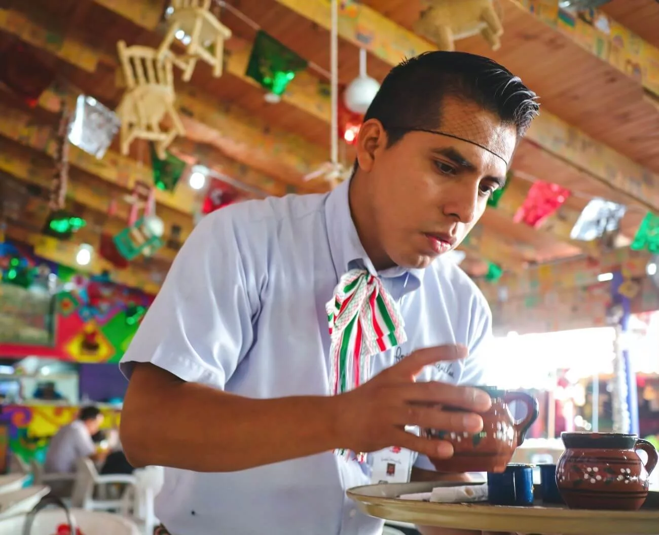 Mexican waiter serving “Cafe de Olla” (Coffee from the pot). This is a sweet, honey-tasting coffee. The only time that I ever drink coffee