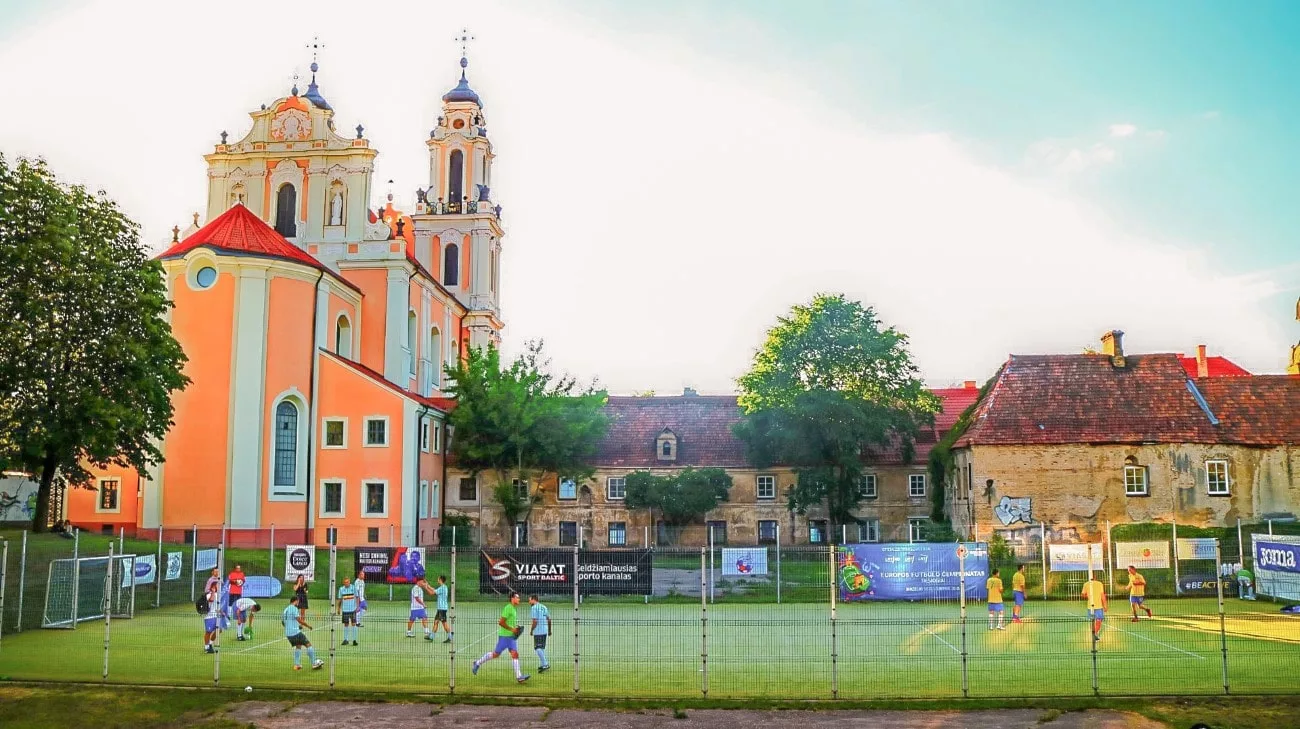 A football match in front of the Baroque Church of St. Catherine